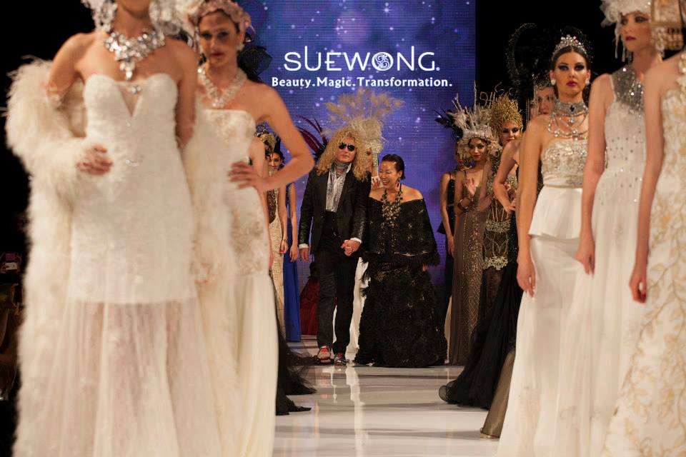 Sue Wong Is Escorted onto the Taglyan Runway After Her Mythos & Goddesses Show (Photo By Jeff Linett)